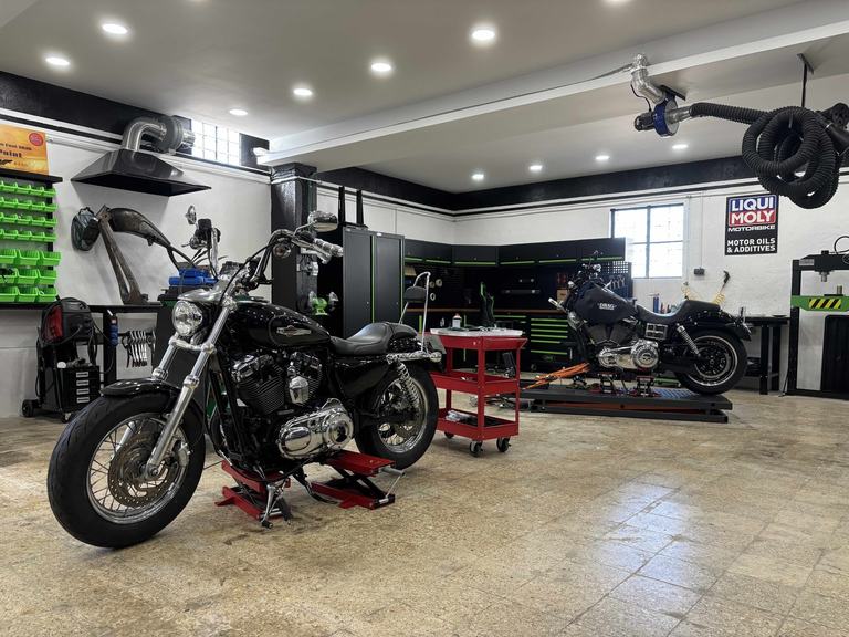 Harley-Davidson motorcycles in service at Iron Custom Motors workshop in Cascais