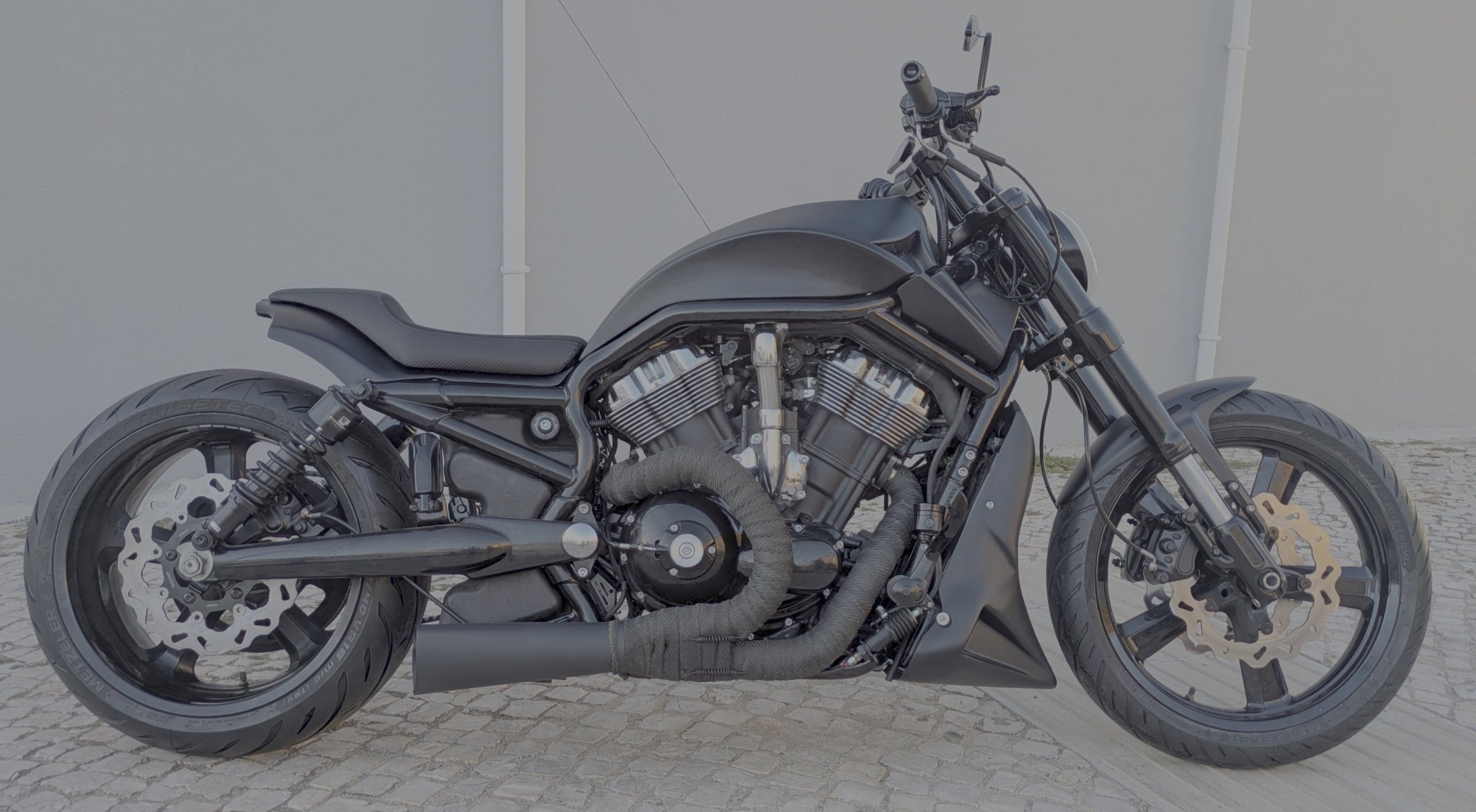 Spaniard — matte black Harley-Davidson V-Rod 2002 with a 240 rear tyre, rebuilt by Iron Custom Motors in Cascais